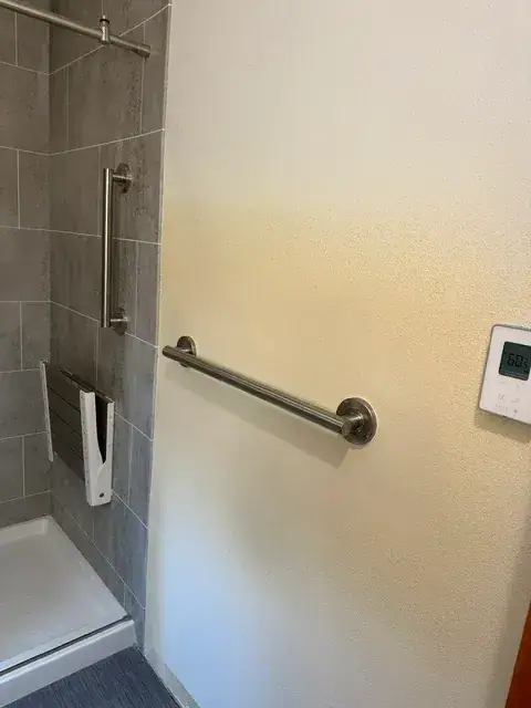 Bathroom remodel in Central Oregon with finished textured drywall beside a tiled shower