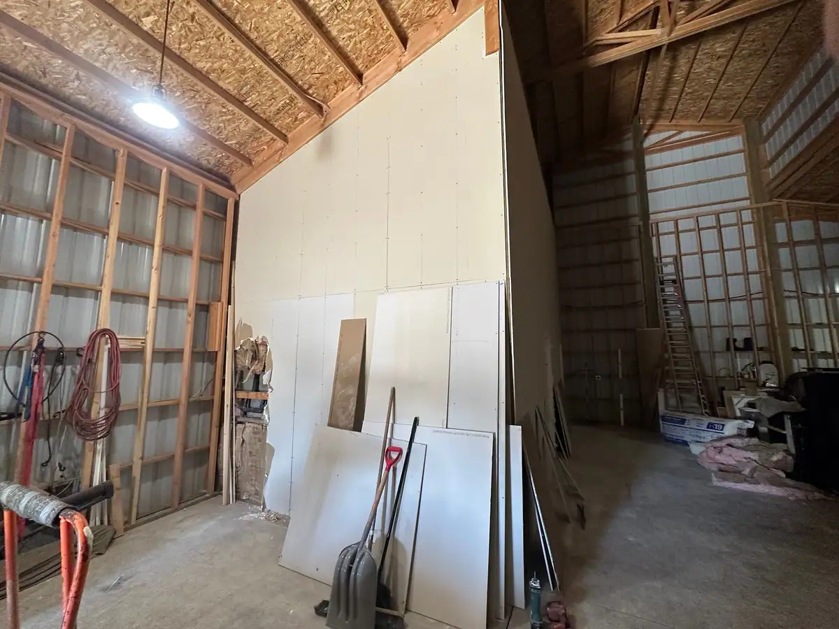 Pole barn interior in Central Oregon with a tall partition wall hung in drywall