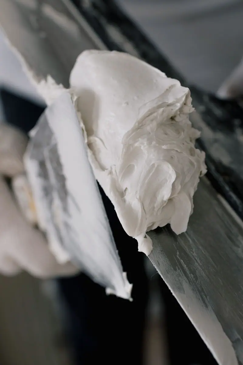 Joint compound loaded on the edge of a taping knife