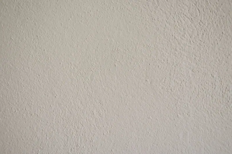 Close view of orange peel wall texture on a cream wall