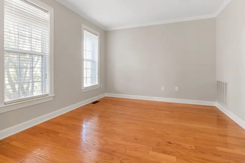 Finished room with smooth grey walls and an oak floor